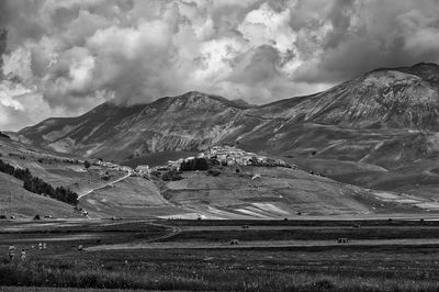 Scenic view of mountains against cloudy sky