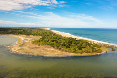 Ocean with a beach in the national park among the jungle.