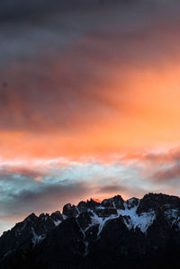 Scenic view of snowcapped mountains against sky during sunset