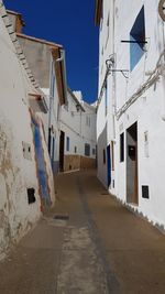 Narrow alley amidst buildings in town