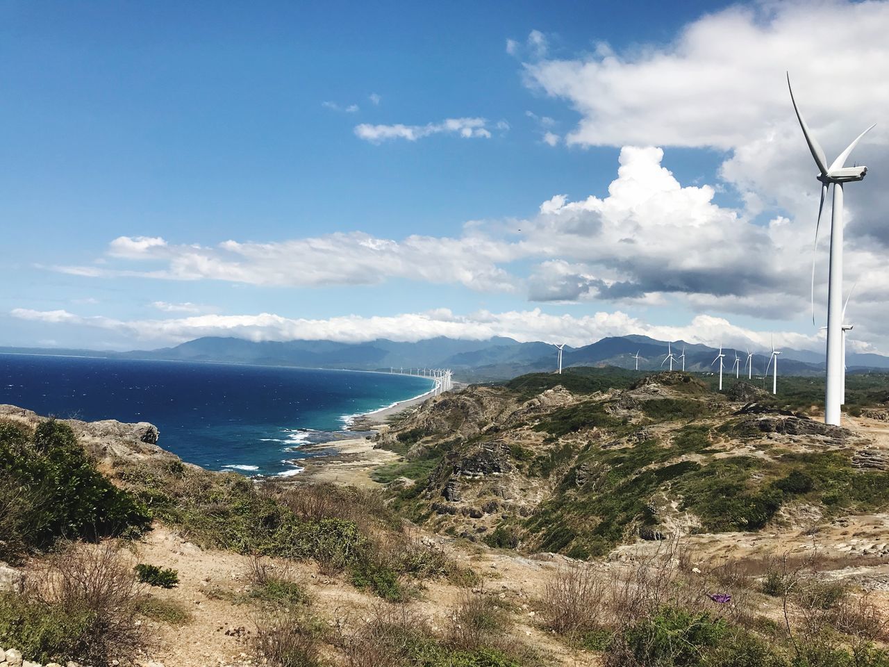 sky, scenics - nature, water, beauty in nature, tranquil scene, environment, mountain, tranquility, day, turbine, nature, wind turbine, cloud - sky, plant, land, fuel and power generation, sea, no people, landscape, outdoors