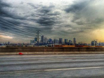 Cityscape against cloudy sky