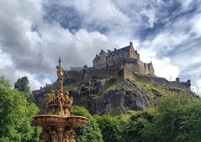 Low angle view of edinburgh castle against cloudy sky