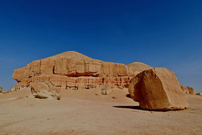 View of desert against clear blue sky