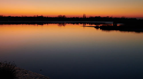 Scenic view of lake against sky during sunset