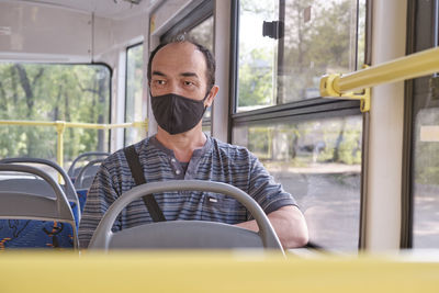 Portrait of man sitting in bus