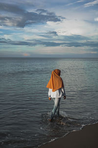 Rear view of person standing on beach