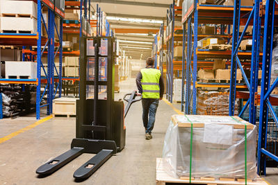 Rear view of man standing in factory