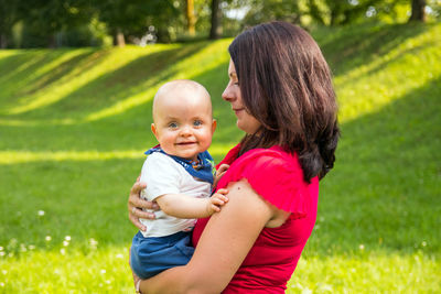 Portrait of mother and son on grass