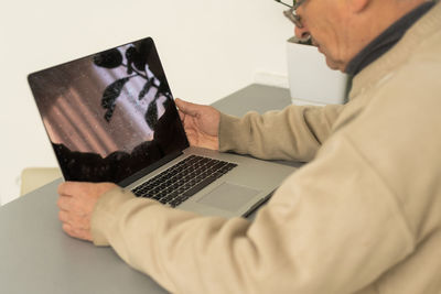Busy smart mature professional man using laptop sitting. middle aged older adult businessman, senior
