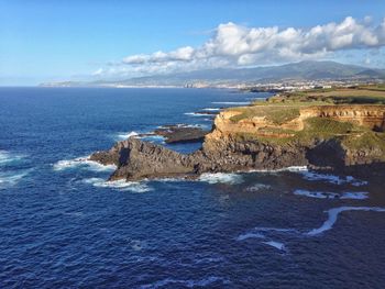 Scenic view of sea against cloudy sky