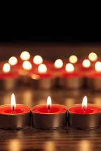 Close-up of lit tea lights on table