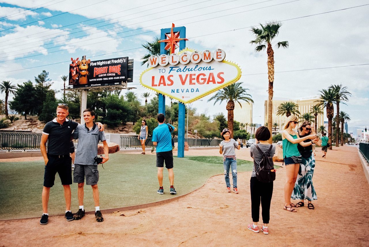 full length, text, sport, day, leisure activity, men, basketball - sport, lifestyles, outdoors, sky, large group of people, real people, tree, basketball hoop, friendship, court, people, adult