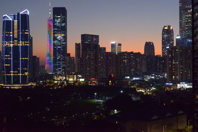 Illuminated buildings against sky at night