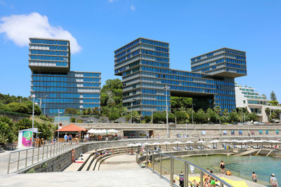 View of swimming pool by buildings against sky