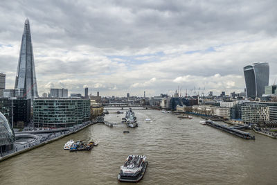 View of modern buildings against cloudy sky