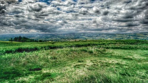 Scenic view of landscape against cloudy sky