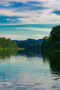 Scenic view of lake in forest against sky