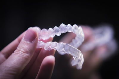 Close-up of hand holding dentures