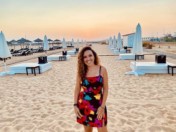 Portrait of young woman standing at beach