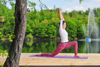 Woman exercising by lake