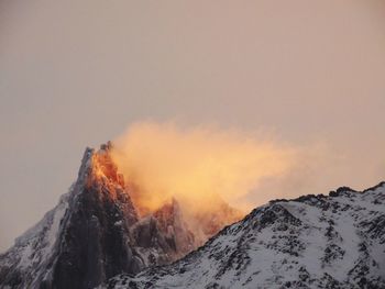 Scenic view of snowcapped mountains against sky during sunset