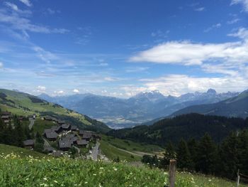 Scenic view of mountains against cloudy sky