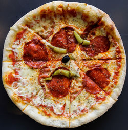 High angle view of pizza on table against black background