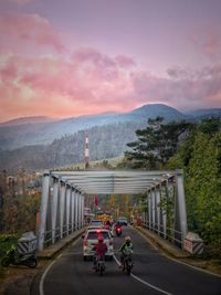 One of some bridges in tawangmangu, indonesia with lawu mountain covered by clouds as a background