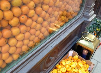 High angle view of oranges at display window by lantern
