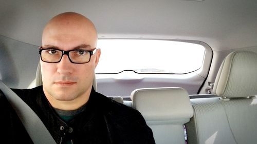 Portrait of mature man sitting in car