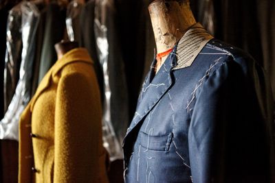 Rear view of male mannequin standing against wall