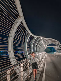 Woman on the bridge at night