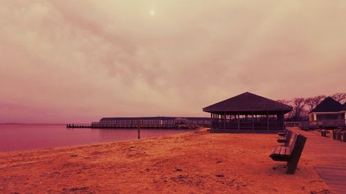 Pier on sea at sunset