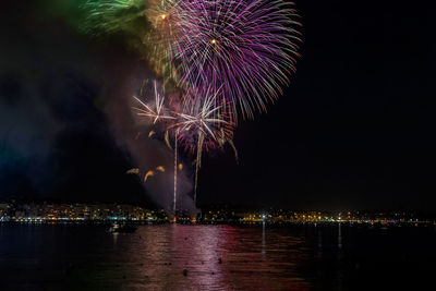 Firework display over city at night