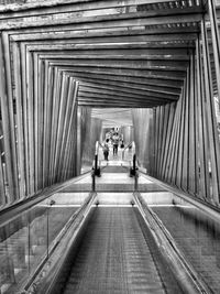 Rear view of people walking in corridor