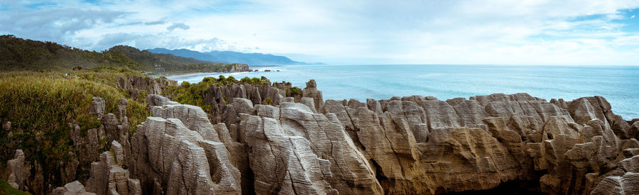 Panoramic view of sea against sky, with pancake rock formation