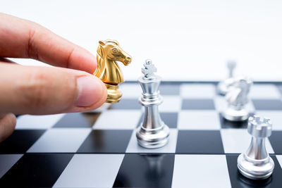 Close-up of hand of chess pieces