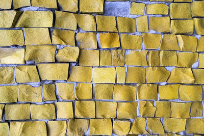 Yellow or brown abstract tile mosaic wall or floor as decorative background. soft focus.