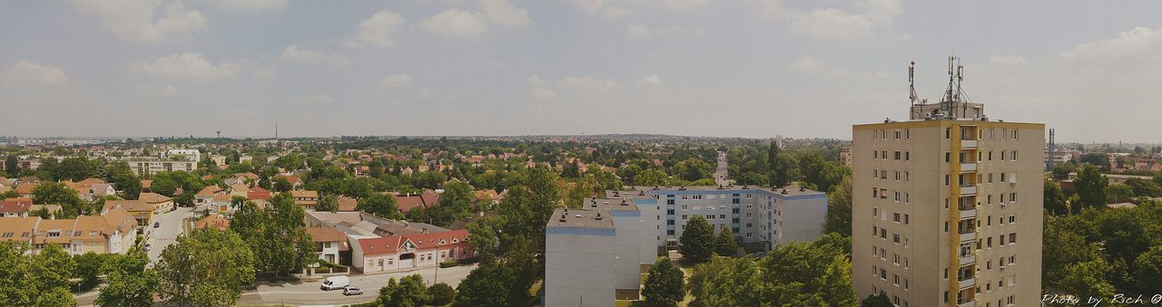 CITY BUILDINGS AGAINST CLOUDY SKY