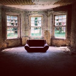 Empty sofa in abandoned building