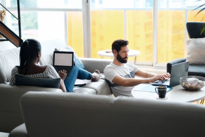 People sitting on sofa at home