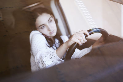 Portrait of young woman sitting outdoors