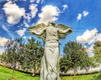 Low angle view of statue against trees