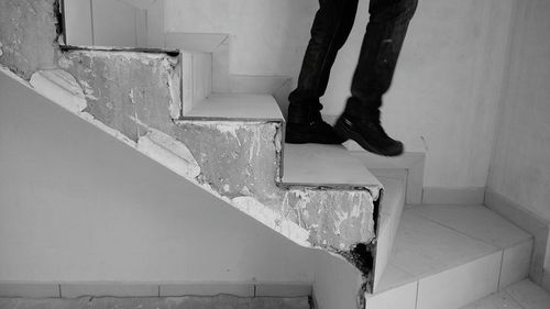 Low section of person standing on staircase