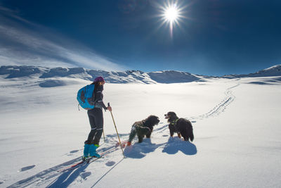 People with dog on snow
