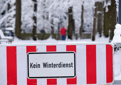 Close-up of arrow sign on snow