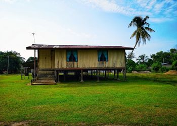 Built structure on field against sky