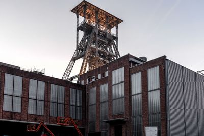 Low angle view of factory against clear sky
