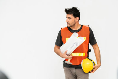 Young man standing against white background